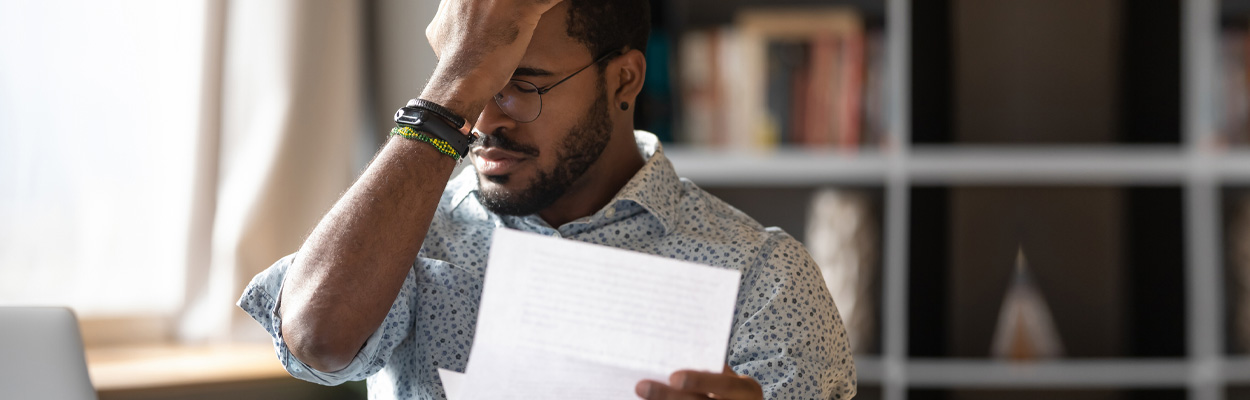 Man looking stressed over papers