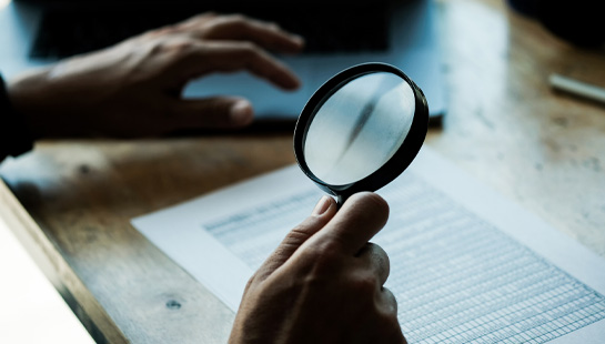 magnifying glass reading documents