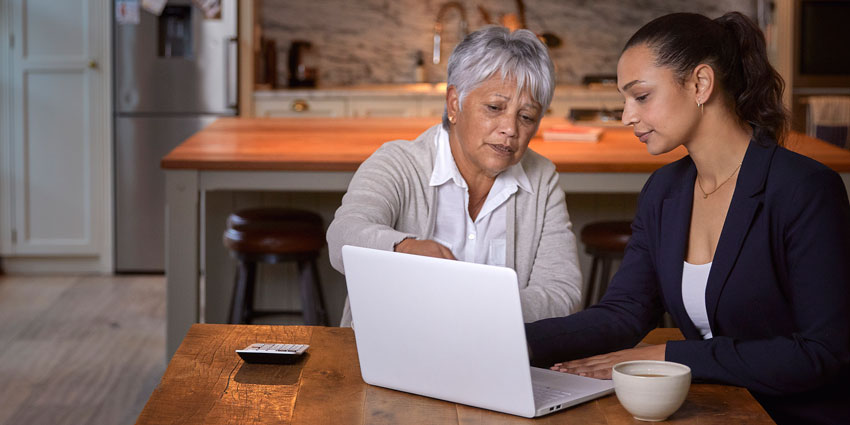 mother and daughter working at a laptop