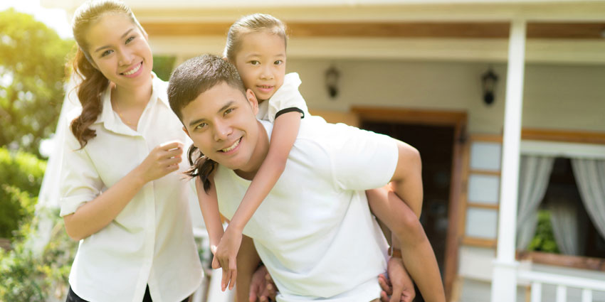 family in front of home